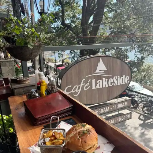 Cafe Lakeside signboard with a burger and potato wedges served on a balcony with lake views in Nainital.