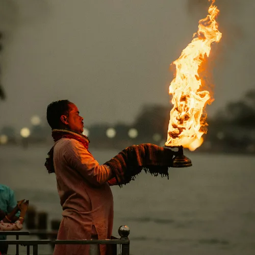 A priest performing the traditional Ganga Aarti in Rishikesh during the evening ceremony on the riverbank.