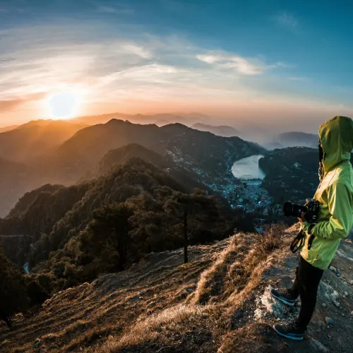 Traveller enjoying sunrise view over Nainital hills and Naini Lake